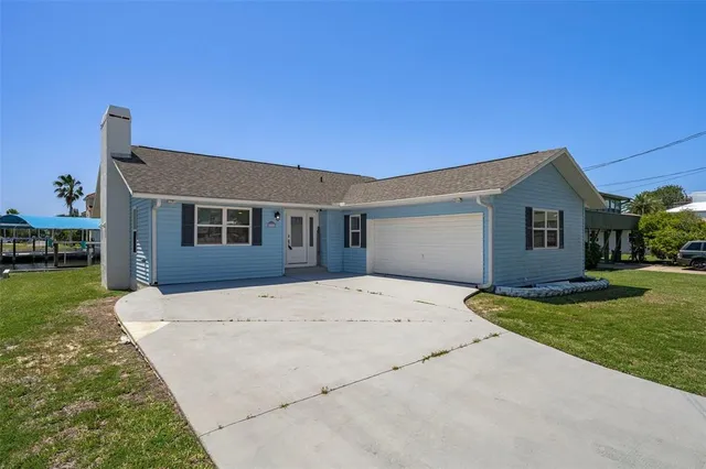 a front view of a house with a garden and yard