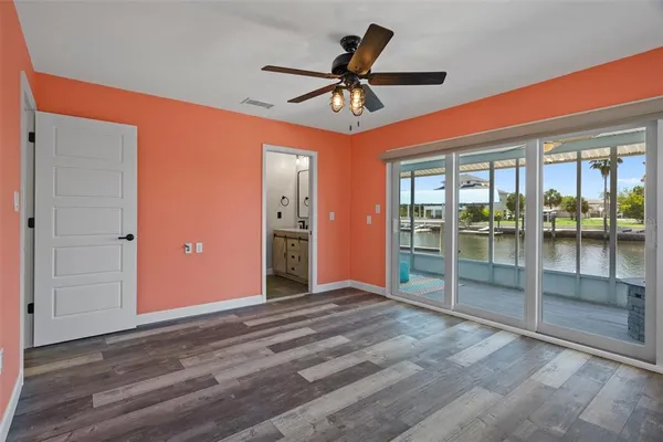 an empty room with wooden floor and outdoor view