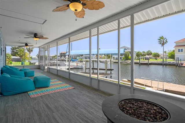 a living room with furniture and a floor to ceiling window