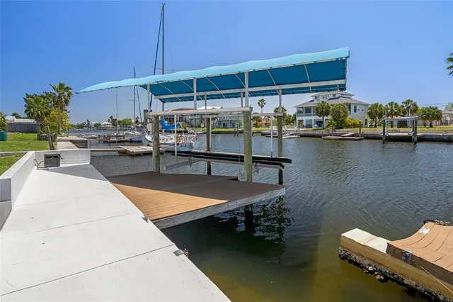 an aerial view of a house with swimming pool and lake view
