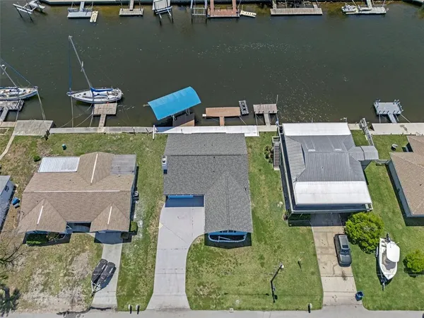 an aerial view of a house with a yard and trees