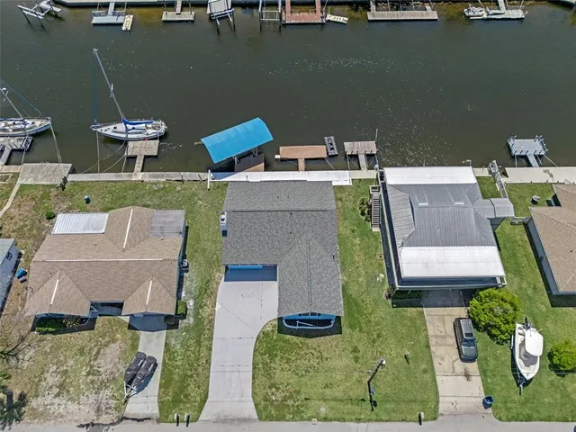 an aerial view of a house with a yard and trees