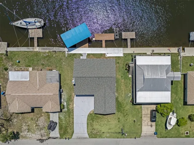 an aerial view of a house with outdoor space