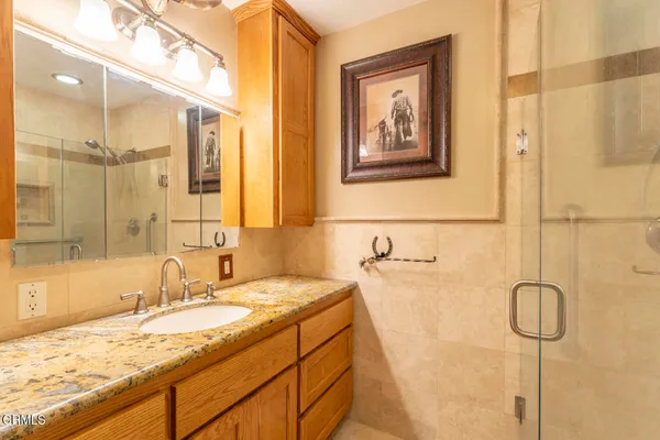 a bathroom with a granite countertop sink mirror and