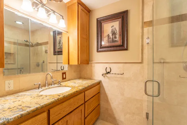 a bathroom with a granite countertop sink mirror and
