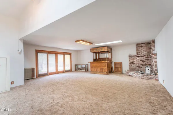 a large room with large windows and brick walls