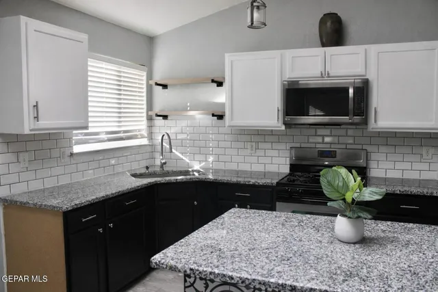 a kitchen with a sink and a window