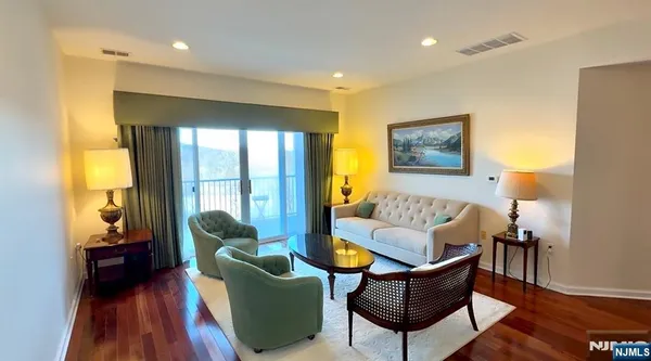 a living room with furniture and a view of kitchen