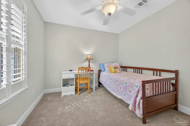 a bed sitting in a bedroom next to a window