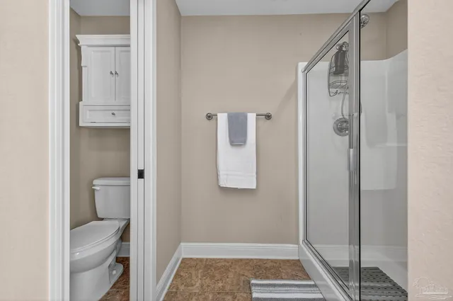 a bathroom with a shower toilet and sink