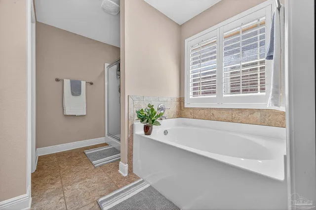 a bathroom with bathtub and window