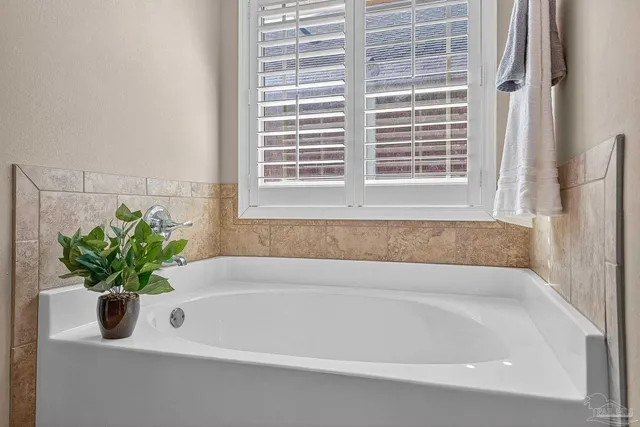 a white bath tub with a window