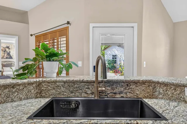 a kitchen with granite countertop a sink and a window