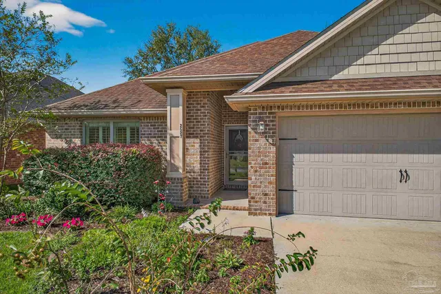 a front view of house with flowers