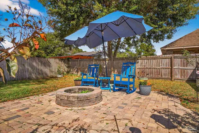 a view of a house with backyard sitting area and garden
