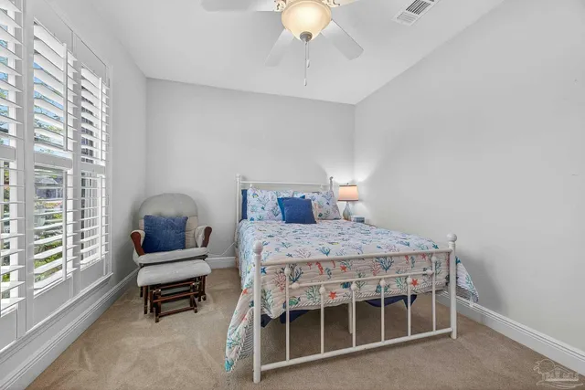 a bedroom with a bed wooden floor and window