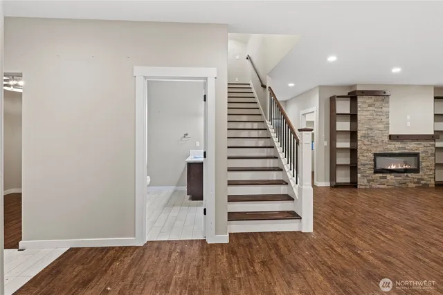 a view of a room with wooden floor and stairs