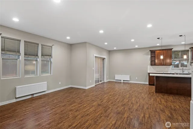 a view of a kitchen with a sink and a large window