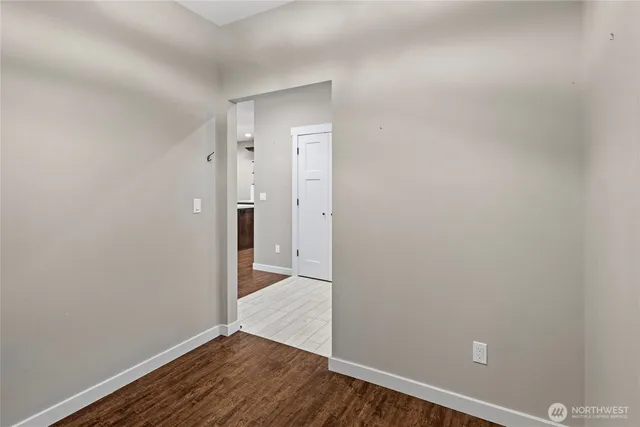 a view of a room with wooden floor