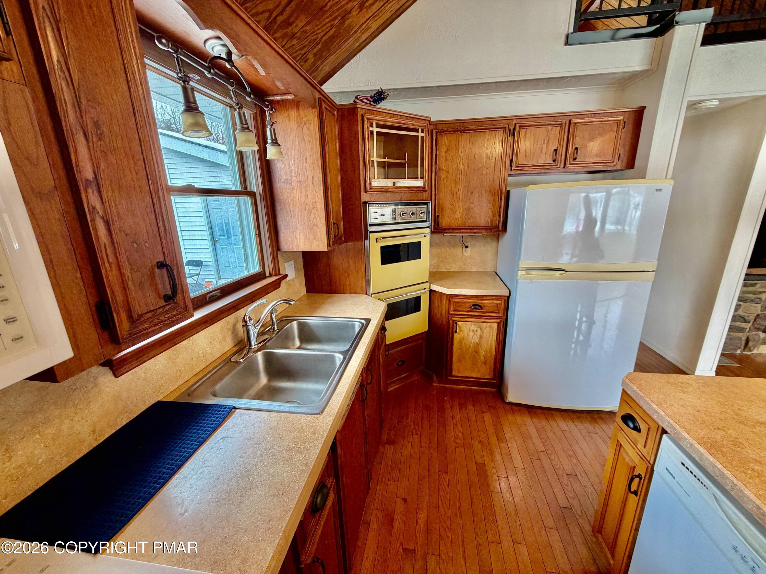 108 Rinker Drive Effort, PA 18330 - Photo 13 of 20 a kitchen with wooden floors and a sink