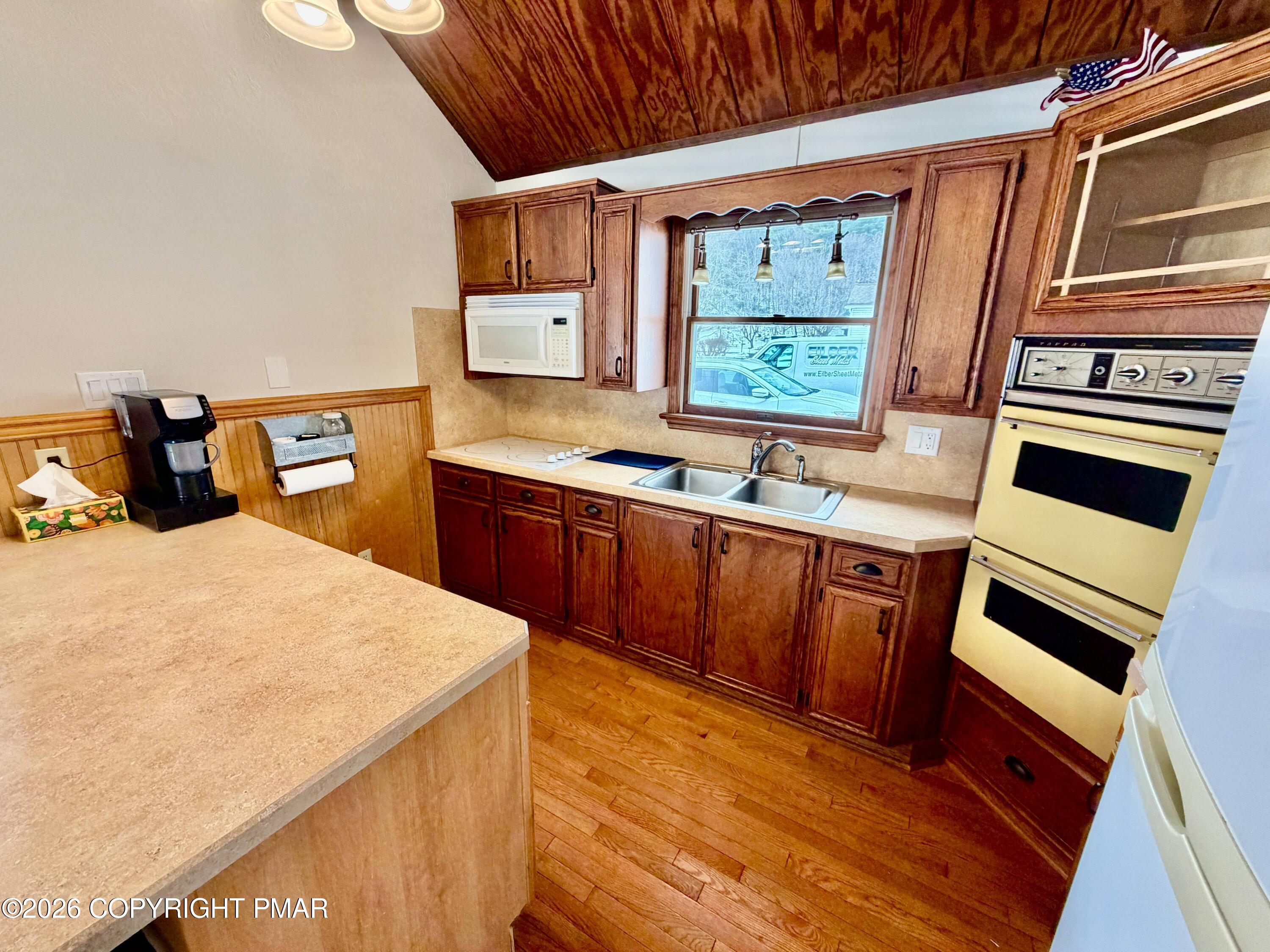 108 Rinker Drive Effort, PA 18330 - Photo 14 of 20 a kitchen with stainless steel appliances kitchen island wooden cabinets a stove a sink and a refrigerator