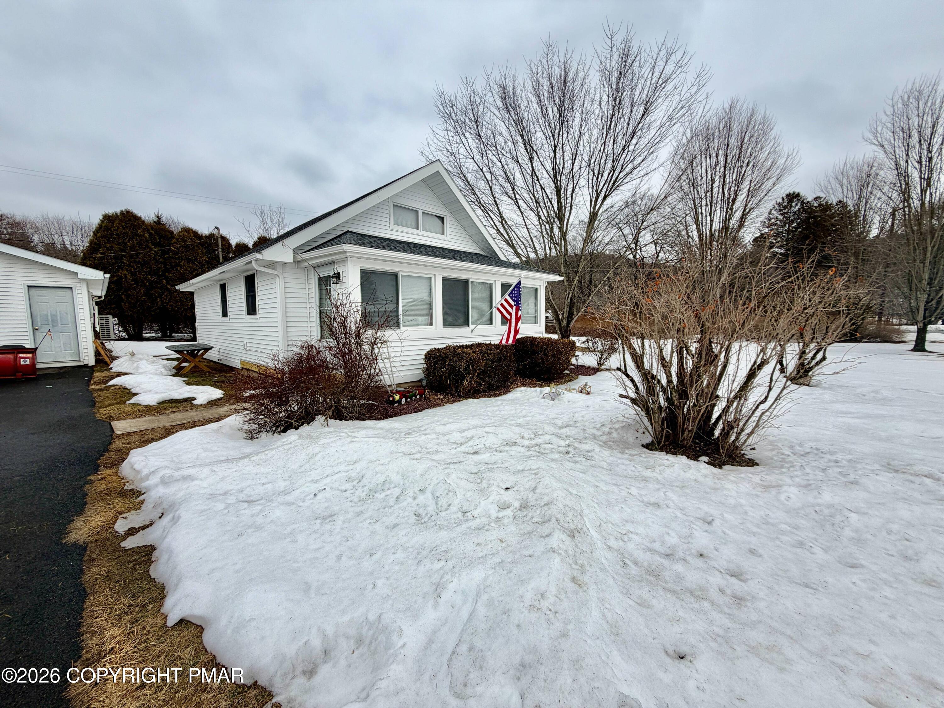 108 Rinker Drive Effort, PA 18330 - Photo 2 of 20 a front view of a house with a yard covered in snow