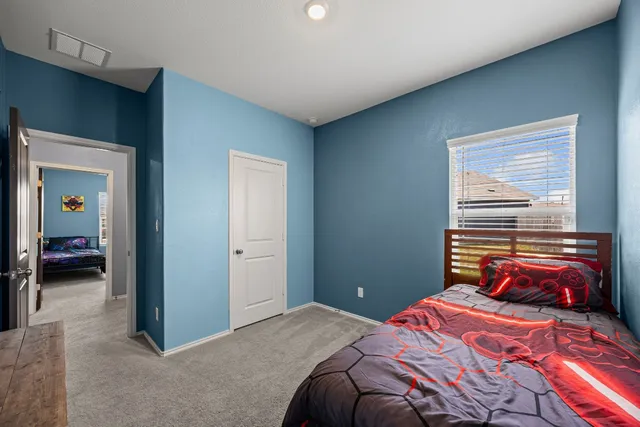 a bedroom with a bed and a window