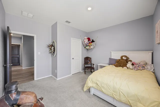 a bedroom with a bed and a couch