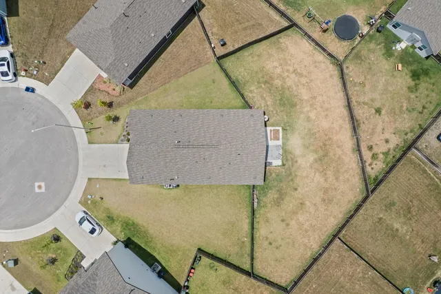 an aerial view of a house with a yard