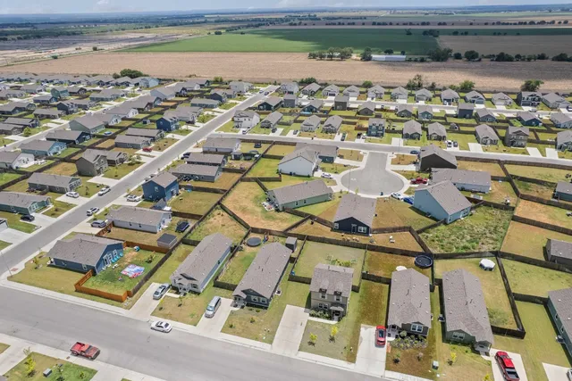 an aerial view of residential houses with outdoor space