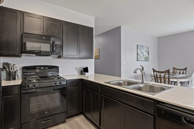 a kitchen with a sink stove and microwave