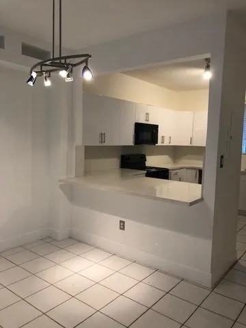 a view of a living room with furniture and a flat screen tv
