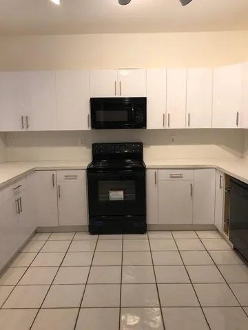 a kitchen with a cabinets and white appliances