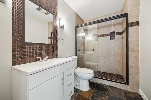 a bathroom with a sink toilet and shower
