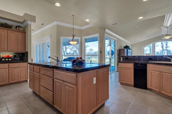 a kitchen with stainless steel appliances granite countertop a sink and cabinets