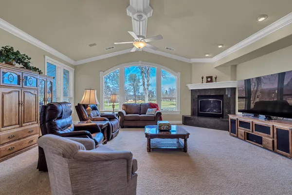 a living room with furniture a fireplace and a flat screen tv