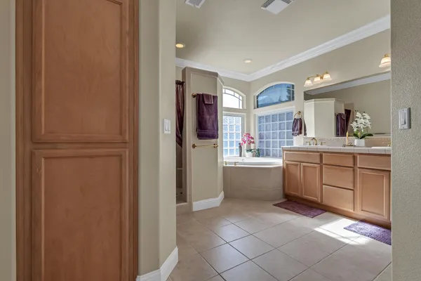 a large bathroom with a sink a mirror and a bathtub
