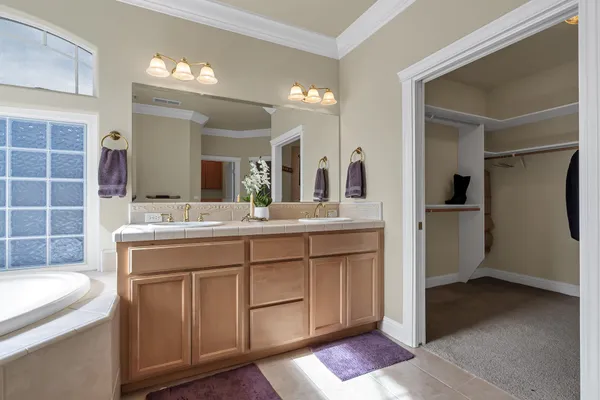 a spacious bathroom with a double vanity sink and a mirror