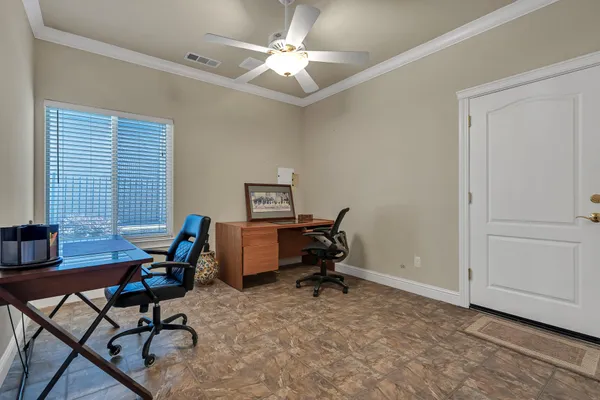 a view of a workspace with furniture and a window