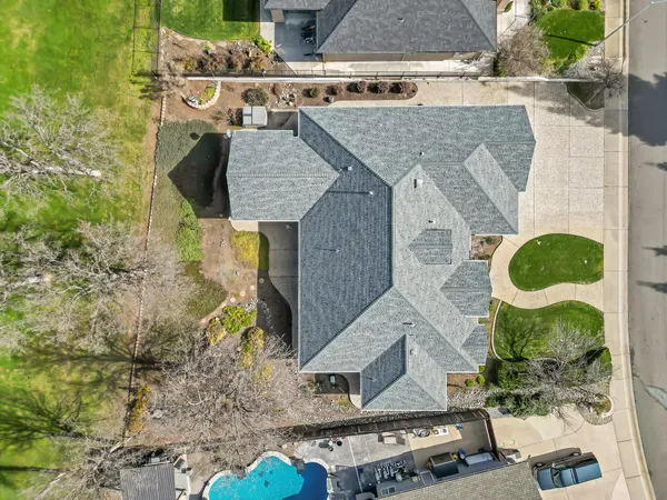 a view of a house with backyard and sitting area