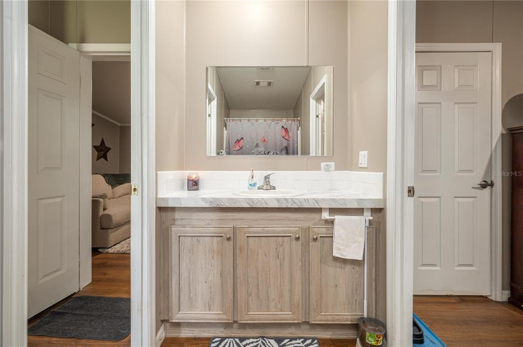 15079 Brahma Road Polk City, FL 33868 - Photo 30 of 40 a bathroom with a sink and a mirror
