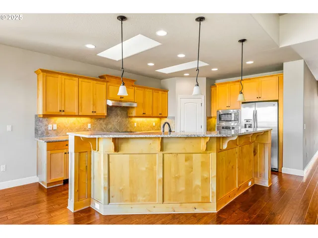 a view of a kitchen with a sink and window