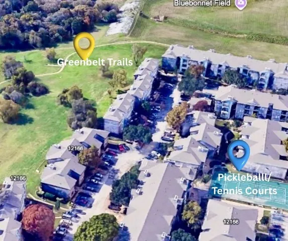 an aerial view of residential houses with outdoor space and swimming pool