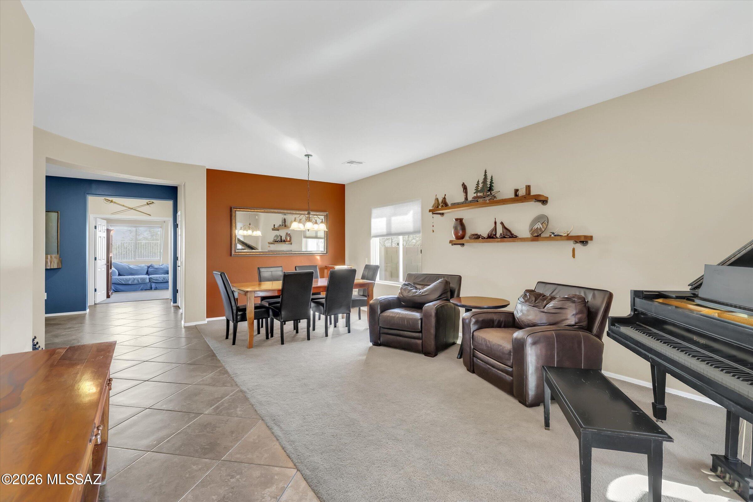 6095 South Jakemp Trail Tucson, AZ 85747 - Photo 9 of 52 a living room with furniture a rug and a window