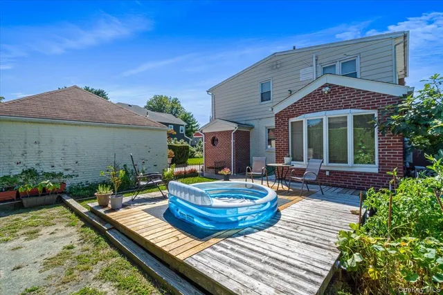 a view of a house with swimming pool and sitting area