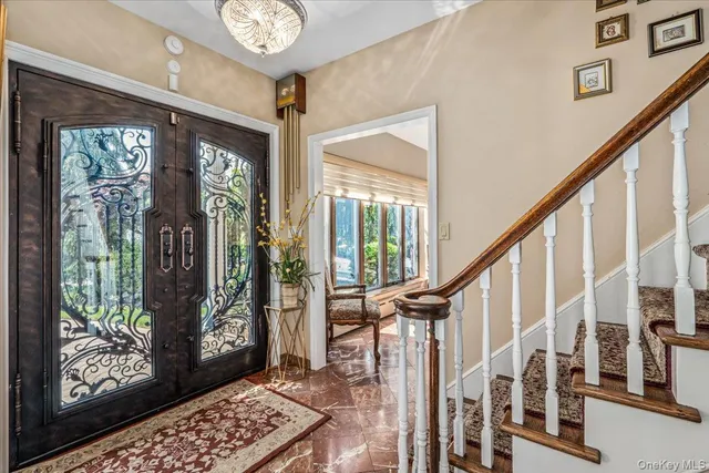 a view of an entryway with wooden floor and windows