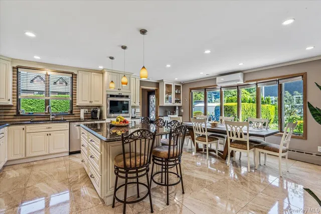 a very nice looking open dining room with a large window