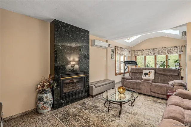 a living room with furniture a window and a flat screen tv