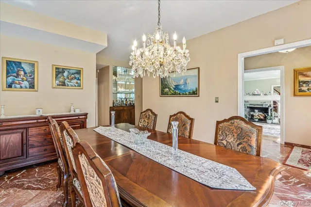 a dining room with furniture a livingroom and chandelier