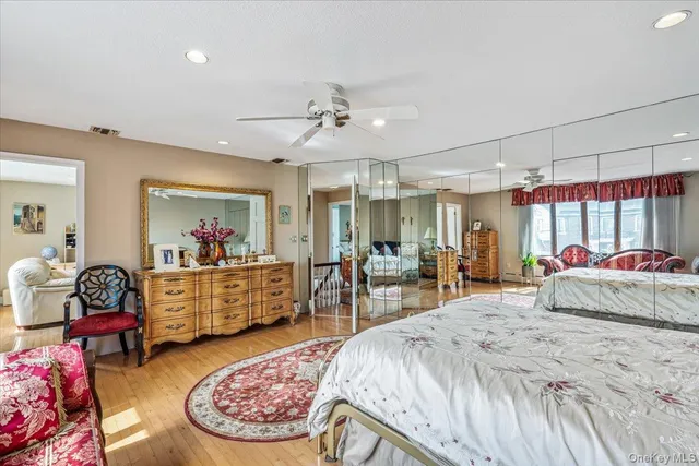 a bed room with a bed and a mirror